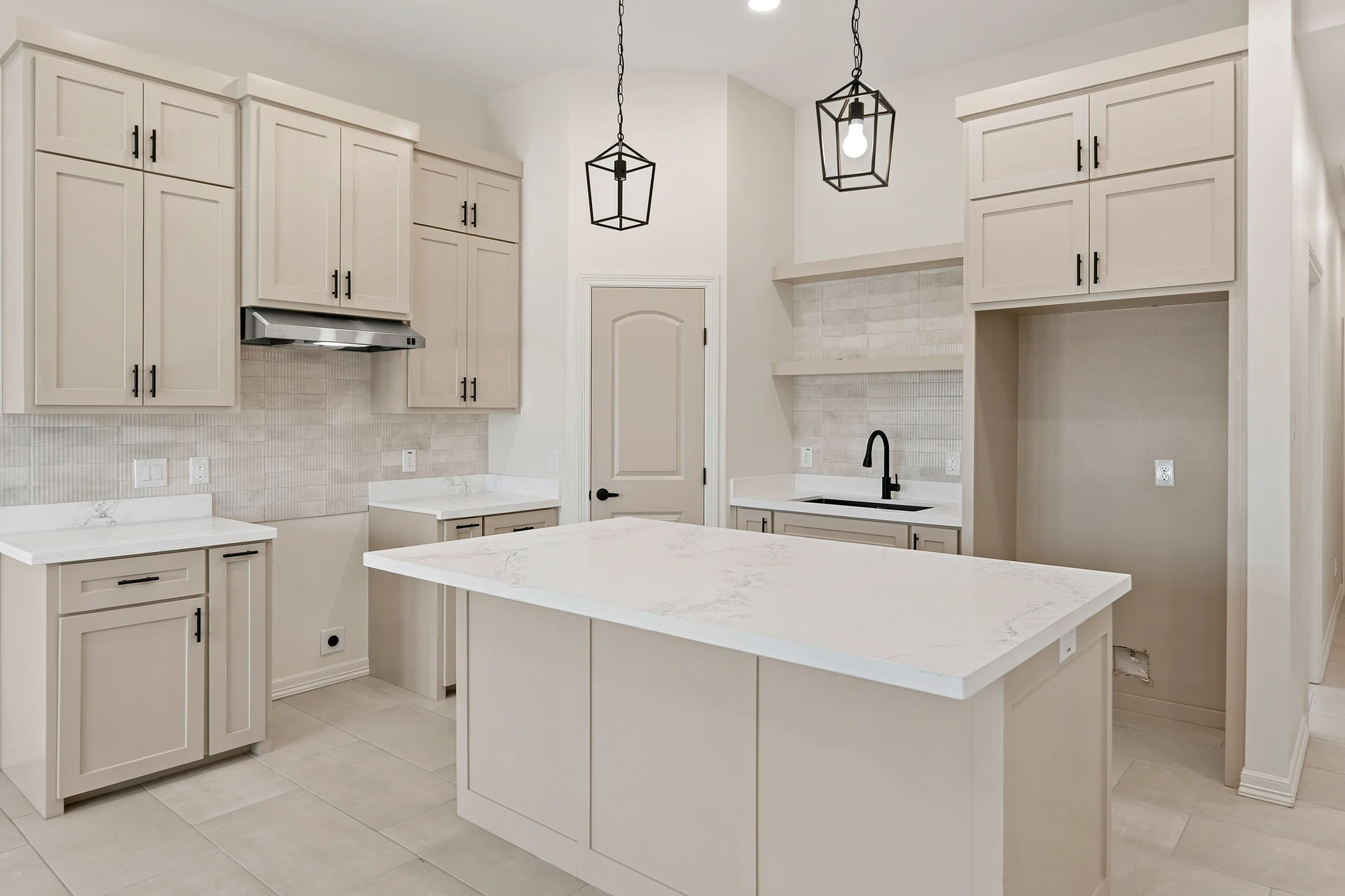 Kitchen of the Board & Batten Farmhouse in Edinburg, TX — custom home built by Go To Guys RGV